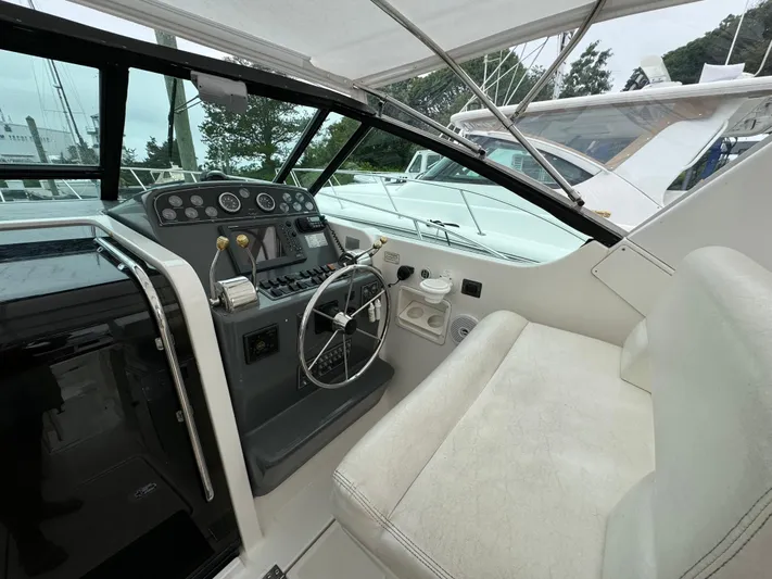 Vixen Yacht Photos Pics 2002 Tiara Yachts 3500 Express helm station with steering wheel and control panel.