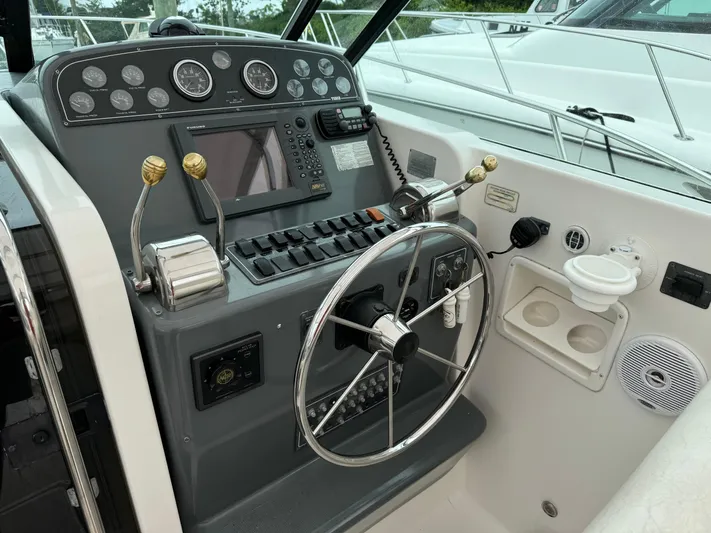 Vixen Yacht Photos Pics Helm of 2002 Tiara Yachts 3500 Express with steering wheel and control panel.