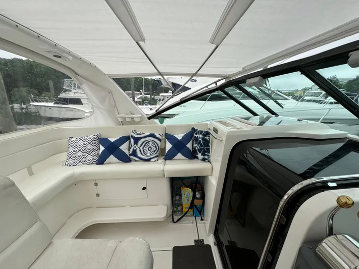 Vixen Yacht Photos Pics Interior seating area of a 2002 Tiara Yachts 3500 Express with decorative pillows.