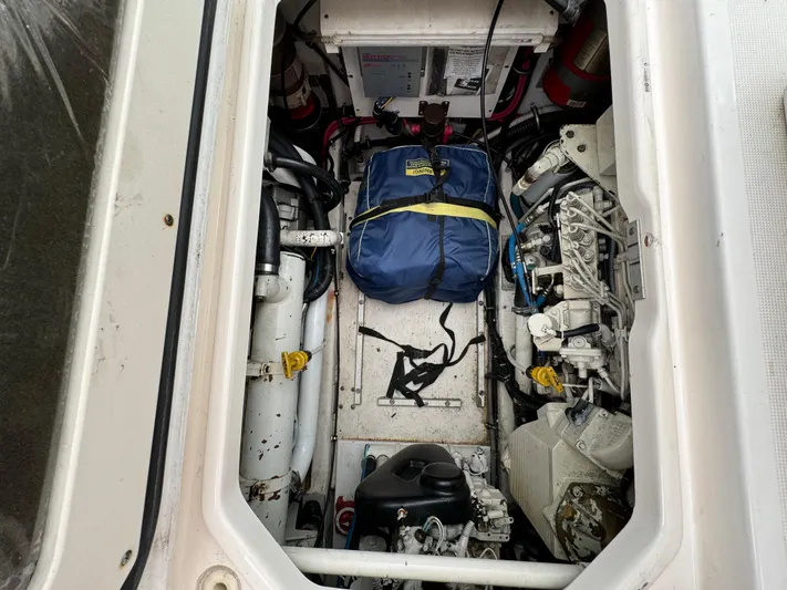 Vixen Yacht Photos Pics Engine compartment of a 2002 Tiara Yachts 3500 Express with a blue bag.