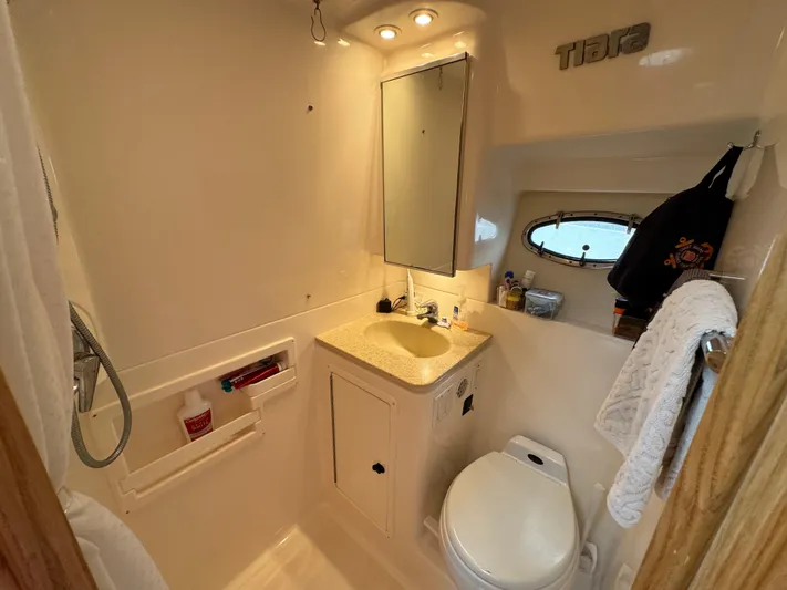 Vixen Yacht Photos Pics 2002 Tiara Yachts 3500 Express bathroom with sink, toilet, and mirror.