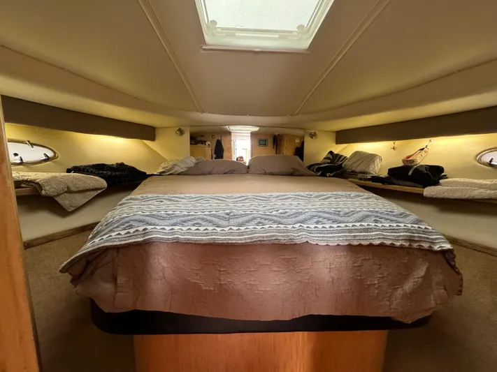 Vixen Yacht Photos Pics Interior cabin of 2002 Tiara Yachts 3500 Express with a cozy bed and skylight.