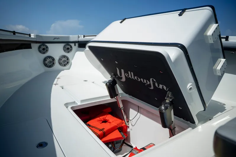  Yacht Photos Pics 2022 Yellowfin 39 boat with open storage compartment and life jackets.