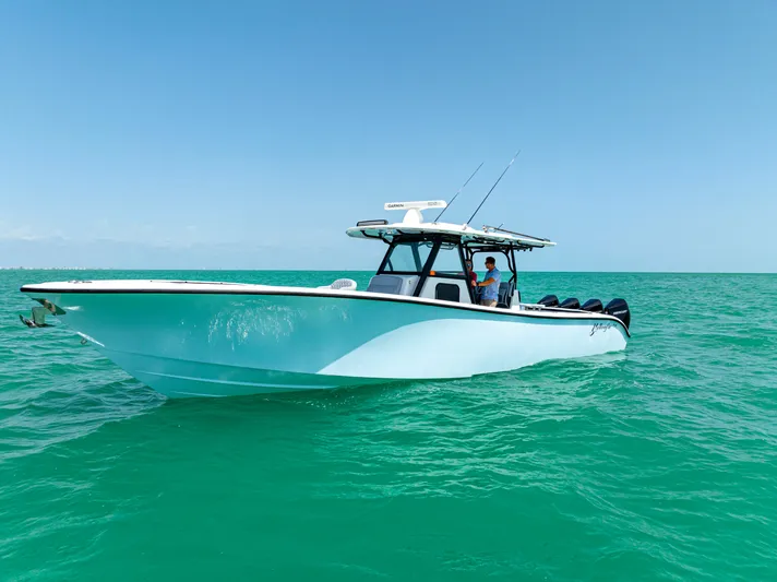  Yacht Photos Pics 2022 Yellowfin 39 boat on turquoise ocean water under clear blue sky.