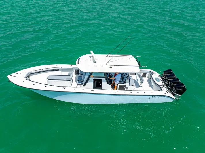  Yacht Photos Pics 2022 Yellowfin 39 boat cruising on clear turquoise water.