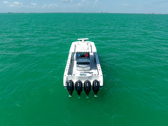  Yacht Photos Pics 2022 Yellowfin 39 boat with four engines on turquoise water.