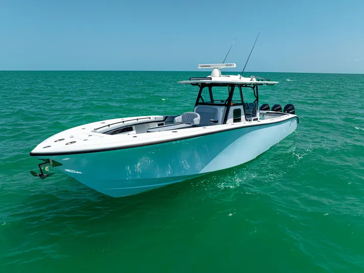  Yacht Photos Pics 2022 Yellowfin 39 boat cruising on clear turquoise waters under a bright blue sky.