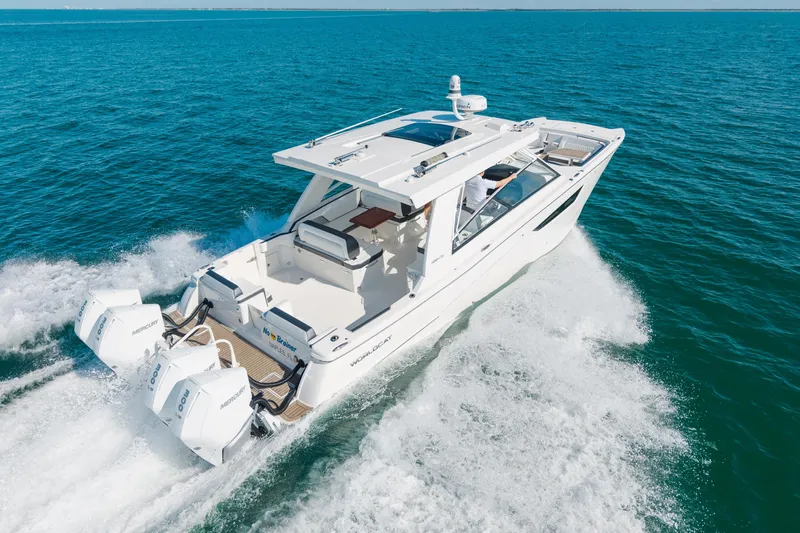  Yacht Photos Pics 2024 World Cat 400 DC-X cruising on open water, showcasing sleek design and powerful engines.