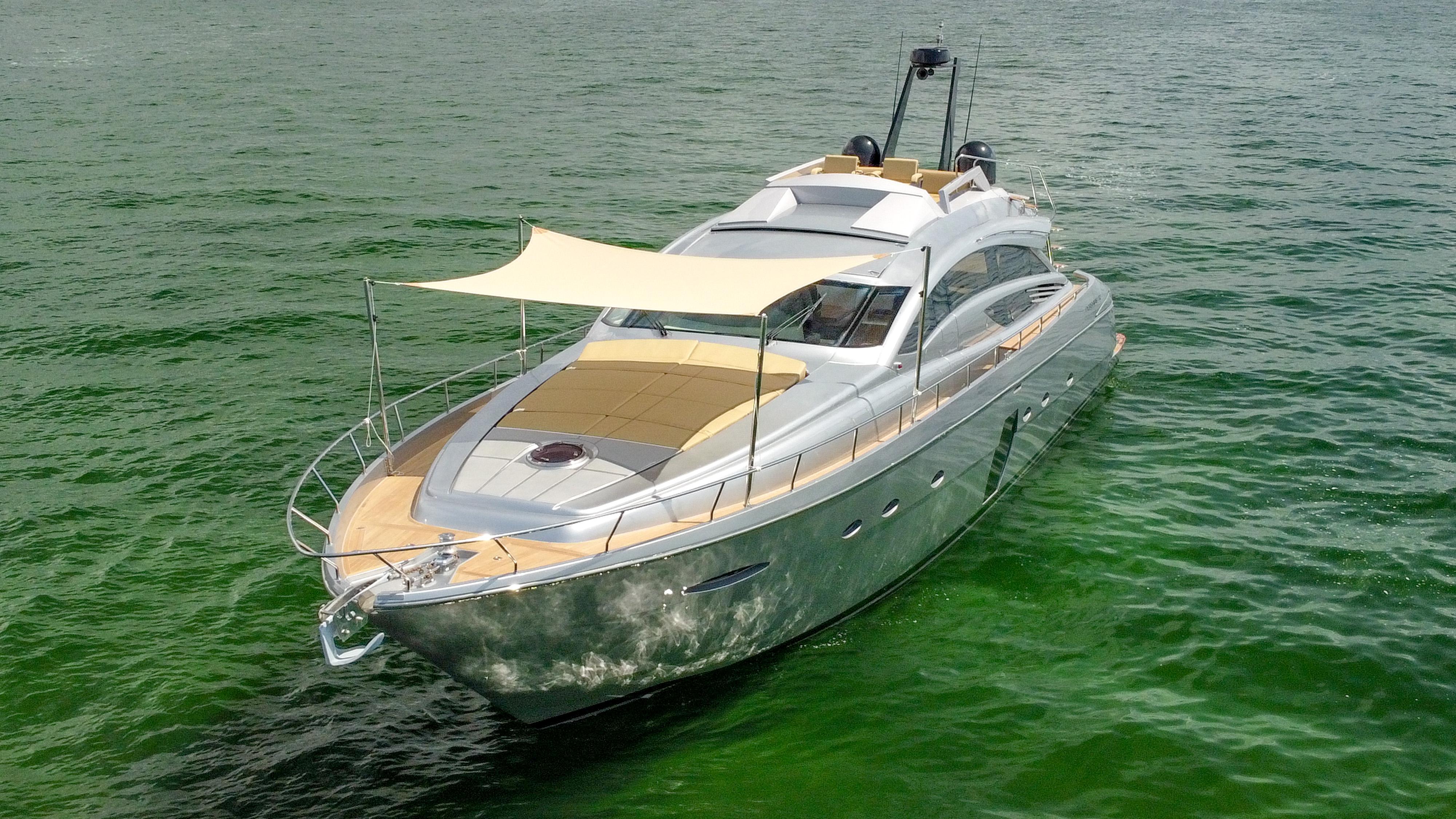 2009 Pershing 72 yacht cruising on green water, featuring sleek design and sunshade canopy.