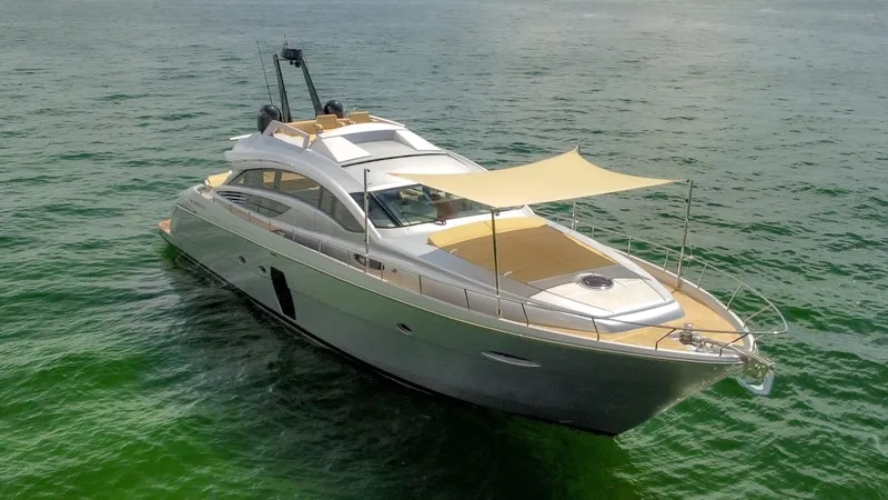  Yacht Photos Pics Luxury 2009 Pershing 72 yacht cruising on calm green waters.