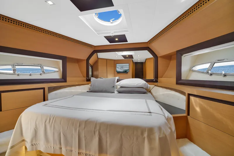  Yacht Photos Pics Luxurious bedroom interior of 2009 Pershing 72 yacht with elegant wood finishes.