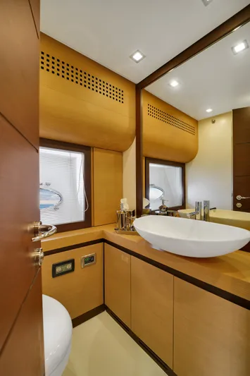  Yacht Photos Pics Luxurious bathroom interior of 2009 Pershing 72 yacht with modern fixtures and wooden accents.