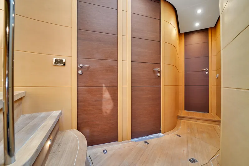  Yacht Photos Pics Luxurious interior hallway of a 2009 Pershing 72 yacht with wooden doors and modern design.