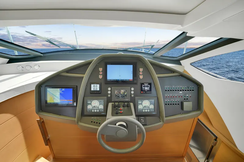  Yacht Photos Pics Control panel of a 2009 Pershing 72 yacht with navigation screens and steering wheel.