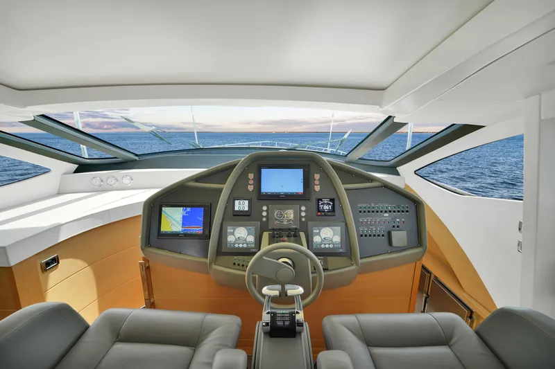  Yacht Photos Pics Cockpit of 2009 Pershing 72 yacht with modern navigation equipment and ocean view.