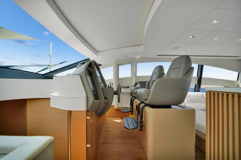  Yacht Photos Pics Luxurious interior of a 2009 Pershing 72 yacht with modern helm and seating.