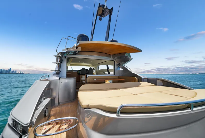  Yacht Photos Pics Luxury 2009 Pershing 72 yacht with spacious deck, cruising on open water.