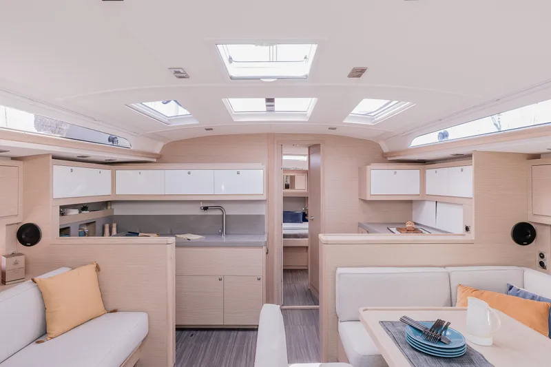 New Stock Boat - Available Now Yacht Photos Pics Luxurious interior of 2023 Dufour 470 yacht, featuring modern kitchen and seating area.