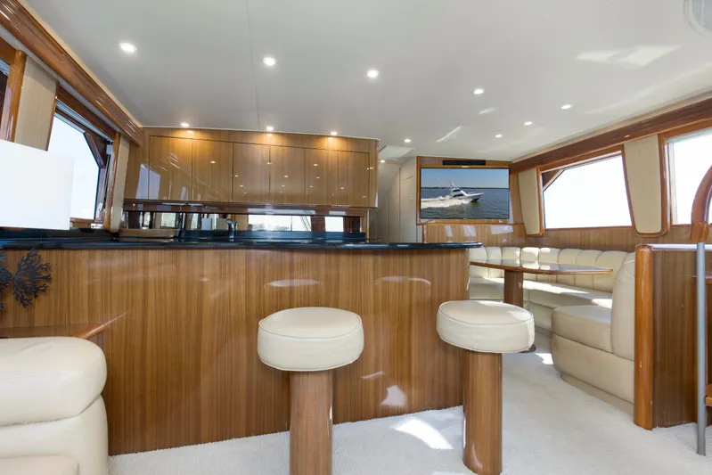 Reel Blues Yacht Photos Pics Luxurious interior of 2007 Viking 64 Enclosed Bridge yacht with elegant wood finishes.