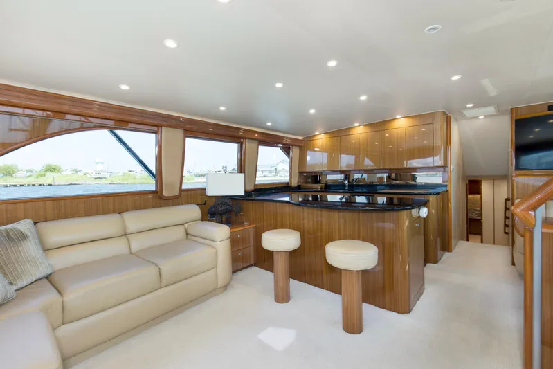 Reel Blues Yacht Photos Pics Luxurious interior of 2007 Viking 64 Enclosed Bridge yacht with elegant seating and wooden finishes.