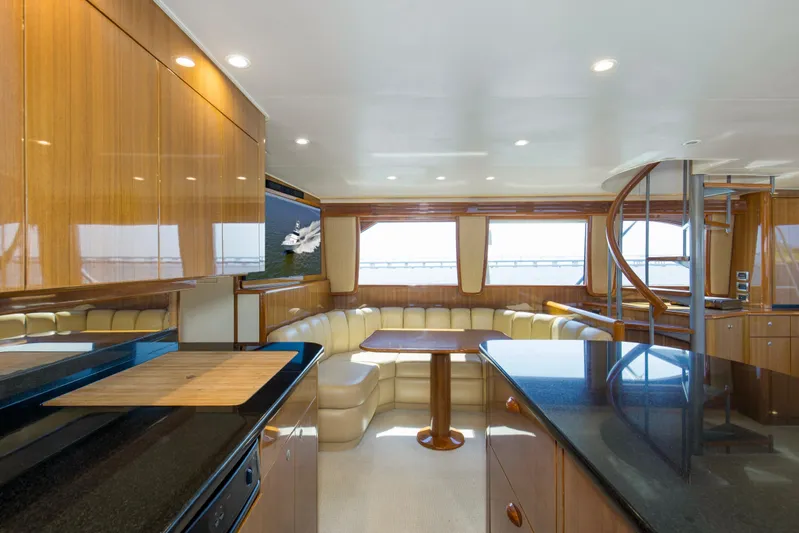 Reel Blues Yacht Photos Pics Luxurious interior of 2007 Viking 64 Enclosed Bridge yacht with modern kitchen and seating area.