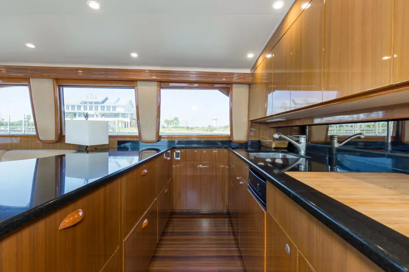 Reel Blues Yacht Photos Pics Luxurious kitchen interior of 2007 Viking 64 Enclosed Bridge yacht with wood cabinetry.