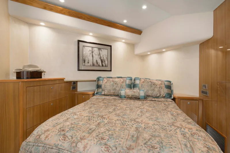 Reel Blues Yacht Photos Pics Luxurious bedroom interior of 2007 Viking 64 Enclosed Bridge yacht with elegant decor.