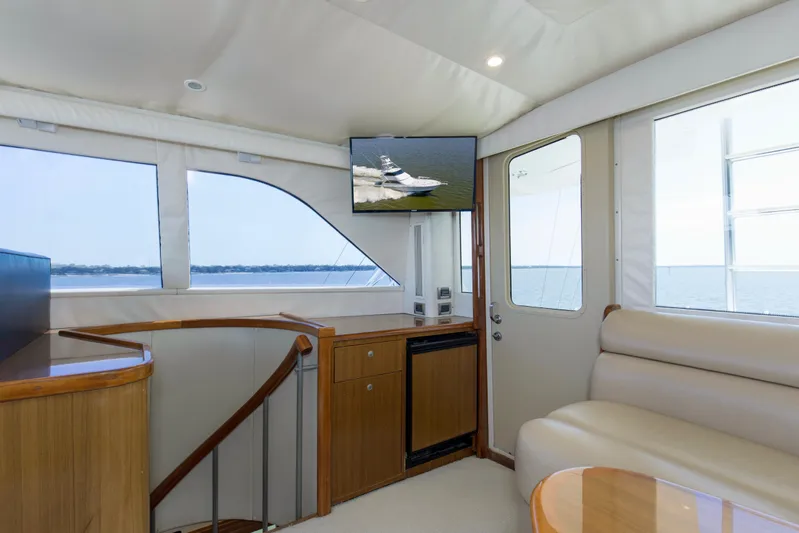 Reel Blues Yacht Photos Pics Interior of 2007 Viking 64 Enclosed Bridge yacht with seating and ocean view.