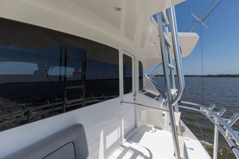 Reel Blues Yacht Photos Pics 2007 Viking 64 Enclosed Bridge yacht, sleek design, cruising on open water.