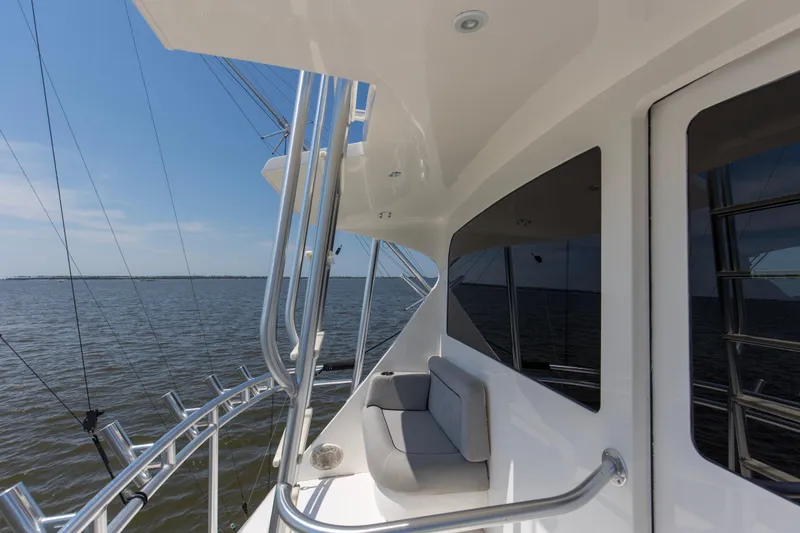 Reel Blues Yacht Photos Pics 2007 Viking 64 Enclosed Bridge yacht, sleek design, ocean view, sunny day.