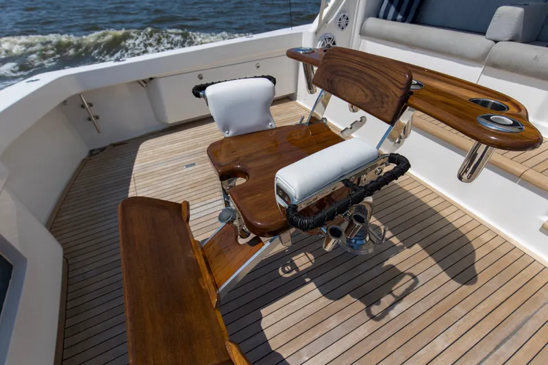 Reel Blues Yacht Photos Pics 2007 Viking 64 Enclosed Bridge yacht deck with wooden fighting chair and rod holders.
