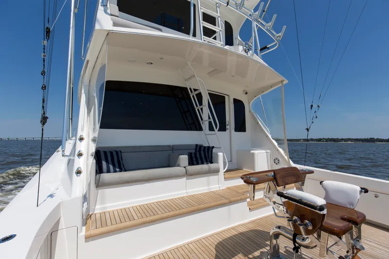 Reel Blues Yacht Photos Pics 2007 Viking 64 Enclosed Bridge yacht with fishing chair and seating area on deck.