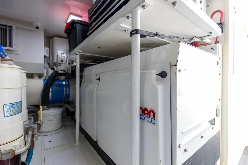 Reel Blues Yacht Photos Pics Engine room of 2007 Viking 64 Enclosed Bridge yacht, featuring mechanical equipment and storage.