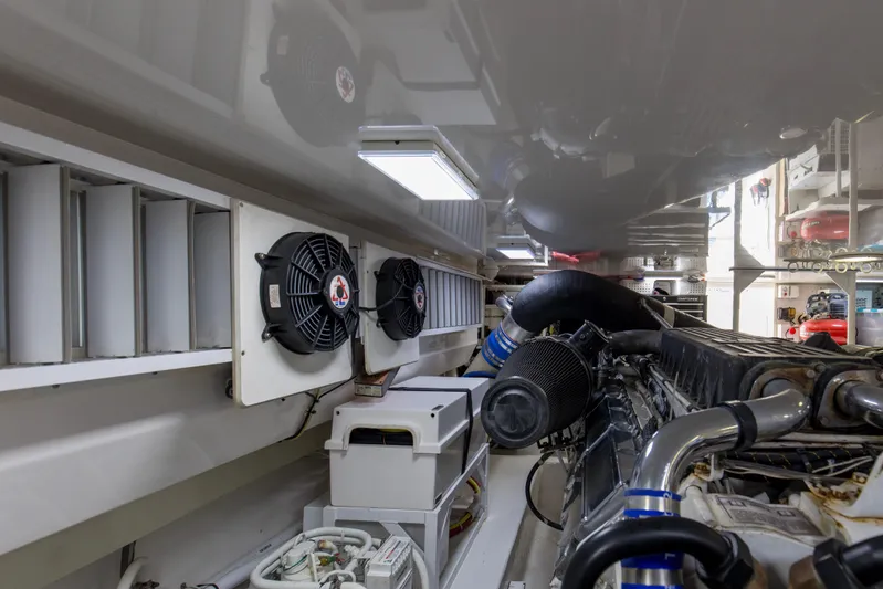 Reel Blues Yacht Photos Pics Engine room of 2007 Viking 64 Enclosed Bridge yacht, showcasing machinery and ventilation systems.