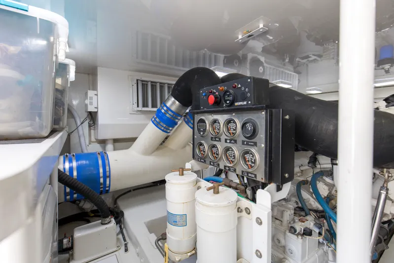 Reel Blues Yacht Photos Pics Engine room of 2007 Viking 64 Enclosed Bridge yacht with control panel and gauges.