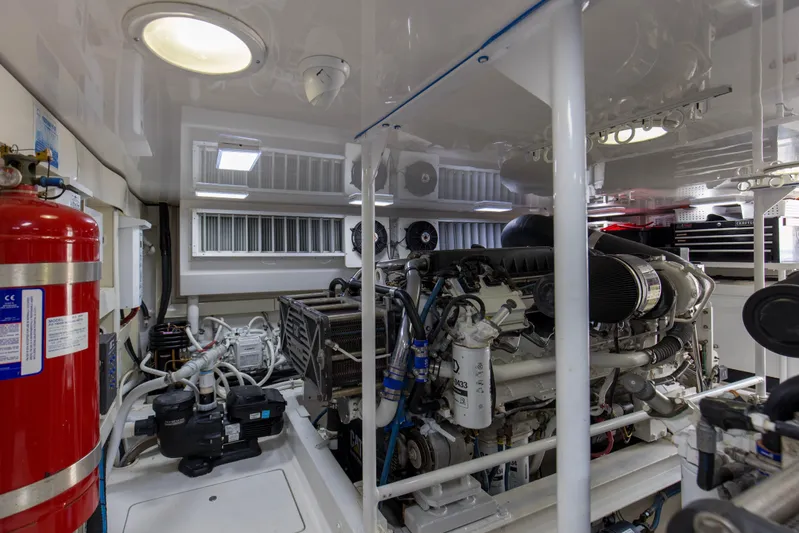 Reel Blues Yacht Photos Pics Engine room of 2007 Viking 64 Enclosed Bridge yacht, featuring machinery and fire extinguisher.