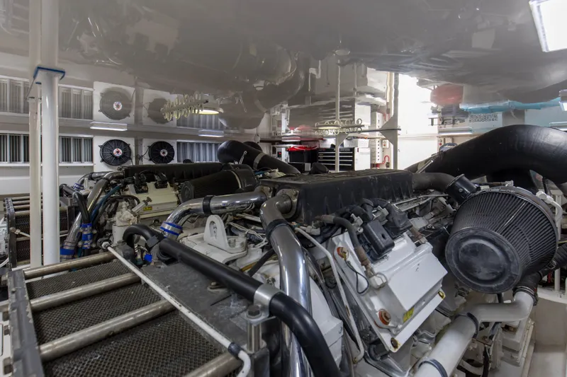 Reel Blues Yacht Photos Pics Engine room of a 2007 Viking 64 Enclosed Bridge yacht, showcasing complex machinery.