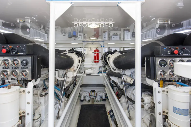 Reel Blues Yacht Photos Pics Engine room of 2007 Viking 64 Enclosed Bridge yacht with Caterpillar controls and gauges.