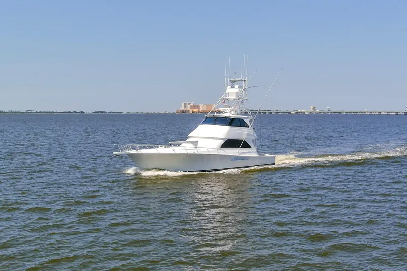 Reel Blues Yacht Photos Pics 2007 Viking 64 Enclosed Bridge yacht cruising on open water.