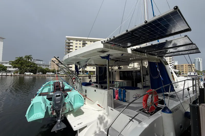 Calacoto Yacht Photos Pics 2023 Royal Cape Catamarans Majestic 530 with solar panels docked in a marina.