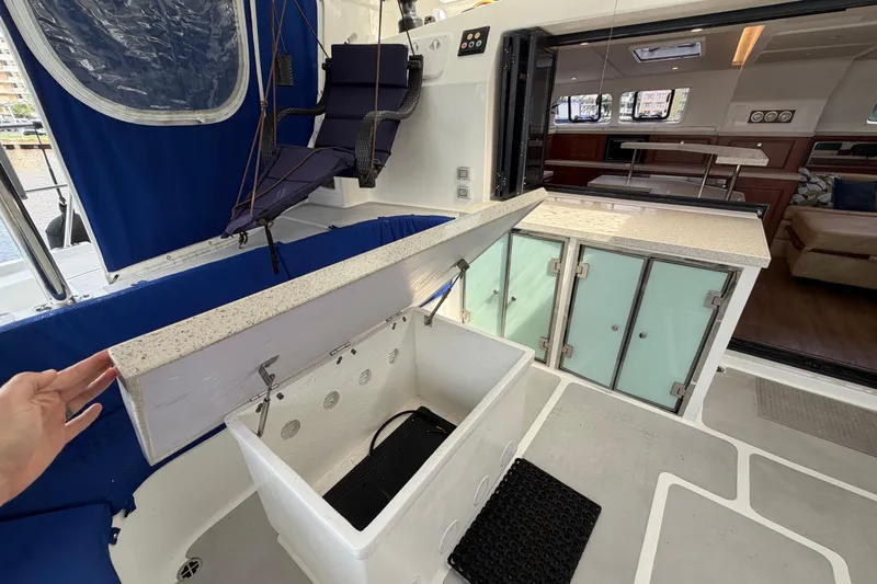 Calacoto Yacht Photos Pics 2023 Royal Cape Catamarans Majestic 530 yacht interior with open storage and seating area.