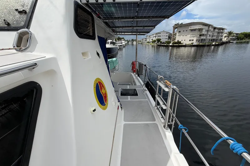 Calacoto Yacht Photos Pics 2023 Royal Cape Catamarans Majestic 530 docked, featuring solar panels and waterfront view.