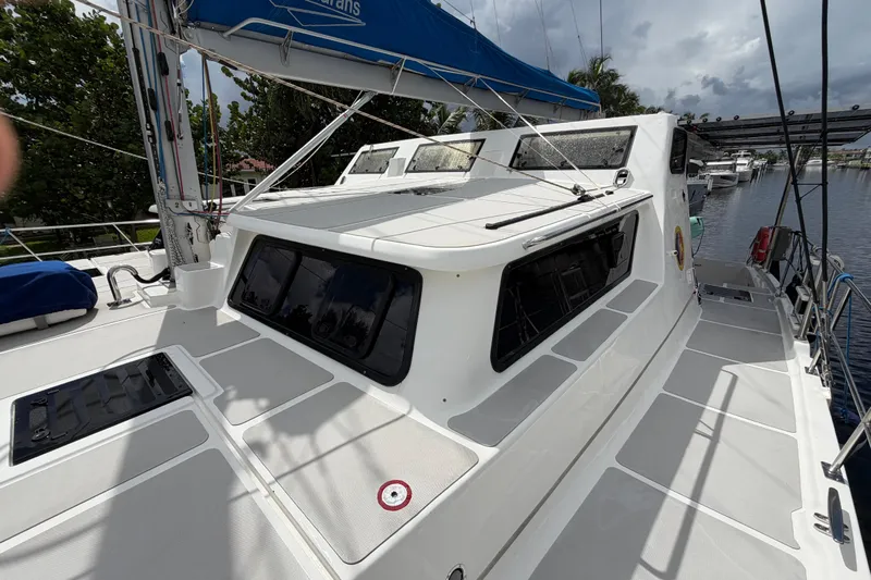 Calacoto Yacht Photos Pics 2023 Royal Cape Catamarans Majestic 530 on a calm waterway, showcasing sleek design and spacious deck.