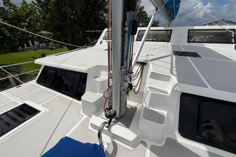 Calacoto Yacht Photos Pics 2023 Royal Cape Catamarans Majestic 530 deck with rigging and windows, under a cloudy sky.