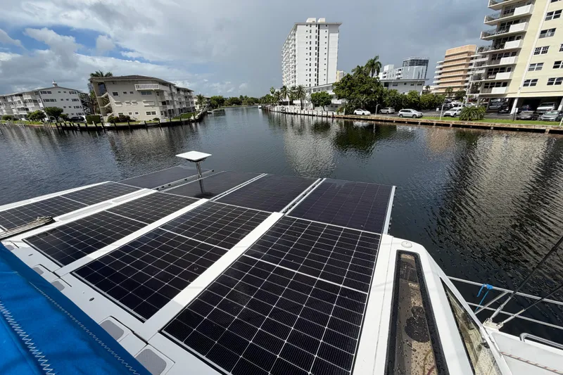 Calacoto Yacht Photos Pics 2023 Royal Cape Catamarans Majestic 530 with solar panels on a scenic waterfront.