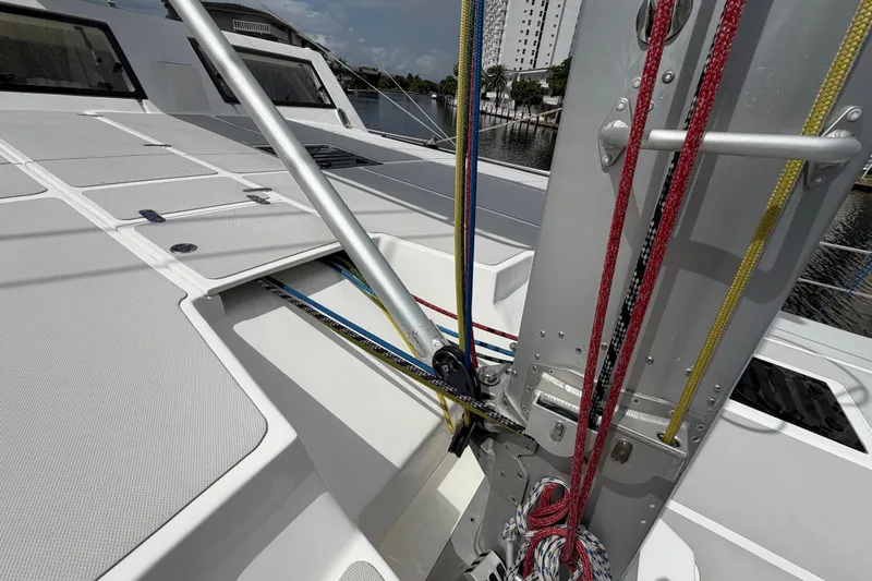 Calacoto Yacht Photos Pics 2023 Royal Cape Catamarans Majestic 530 deck with rigging and hatches, docked by water.