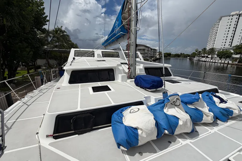 Calacoto Yacht Photos Pics 2023 Royal Cape Catamarans Majestic 530 on a calm waterway, featuring a spacious deck.