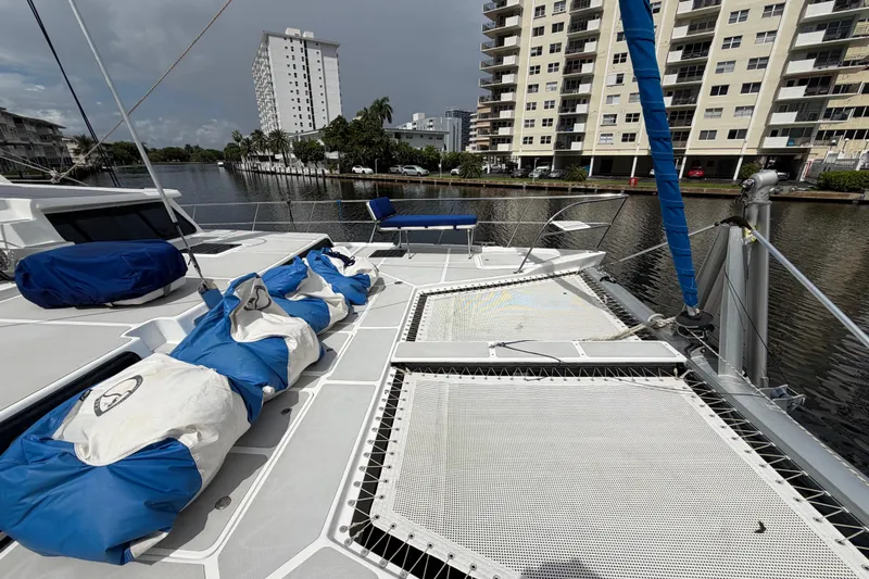 Calacoto Yacht Photos Pics 2023 Royal Cape Catamarans Majestic 530 docked near waterfront buildings.