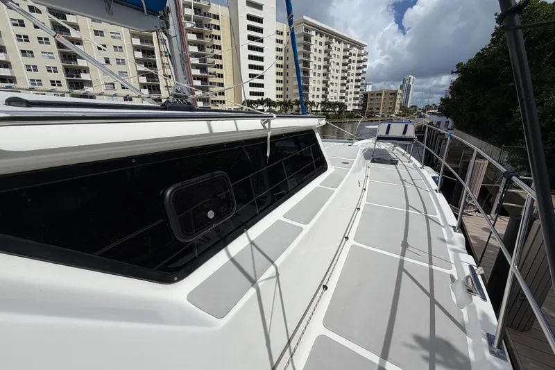 Calacoto Yacht Photos Pics 2023 Royal Cape Catamarans Majestic 530 docked near waterfront buildings.