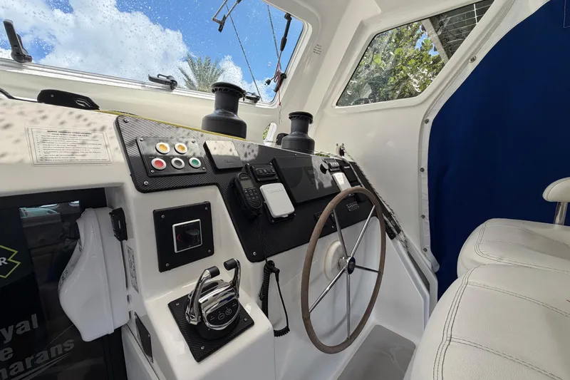Calacoto Yacht Photos Pics Interior helm of 2023 Royal Cape Catamarans Majestic 530, featuring modern controls and steering wheel.